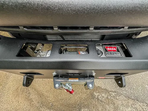 Lower front bumper close-up with winch fairlead and tow hooks.
