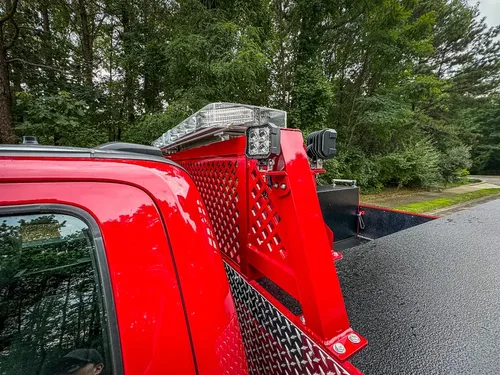 Rear cab window and upper rack support close-up.