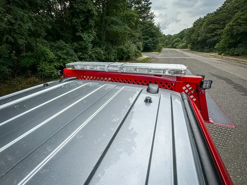 Cab roofline and rear rack lightbar close-up from above.