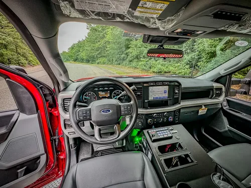 Driver-side interior view with steering wheel and center controls.