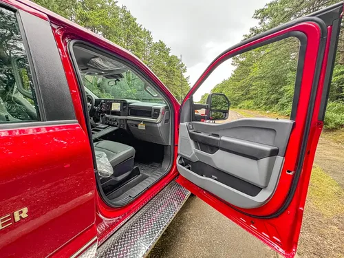 Open front passenger door view with interior door panel and seat.