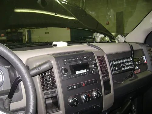 Exterior view of small fire truck showing cab, body compartments, and wheel/tire area.