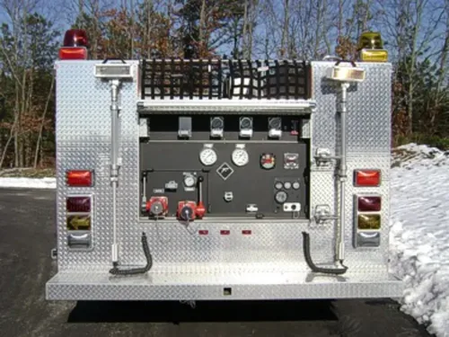 Exterior view of small fire truck showing cab, body compartments, and wheel/tire area.