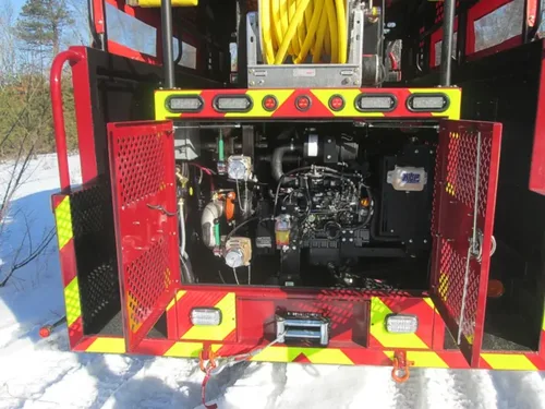 Exterior view of small fire truck showing cab, body compartments, and wheel/tire area.