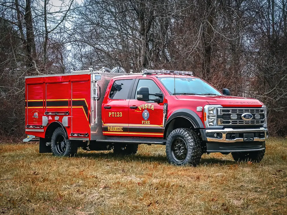 Front-left three-quarter exterior view of the red brush truck.