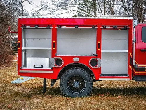 Close-up of open left-side compartments near the rear wheel.