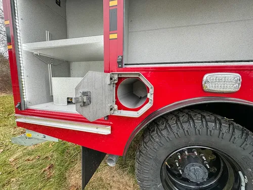 Open lower side compartment with intake port and side marker light.