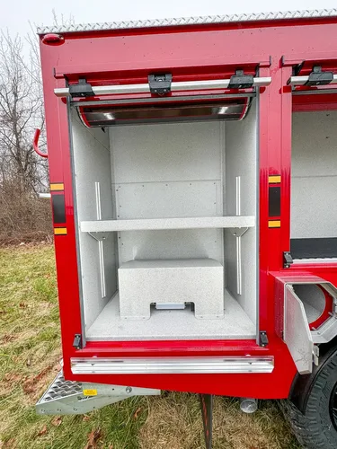 Narrow side compartment with two shelves and empty interior.