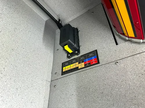 Close-up inside side compartment showing small mounted warning label.