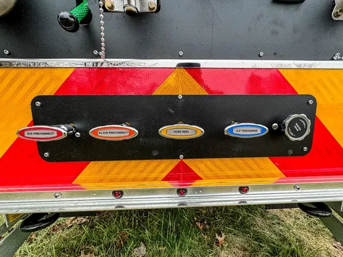Lower rear panel close-up with labeled discharge ports.