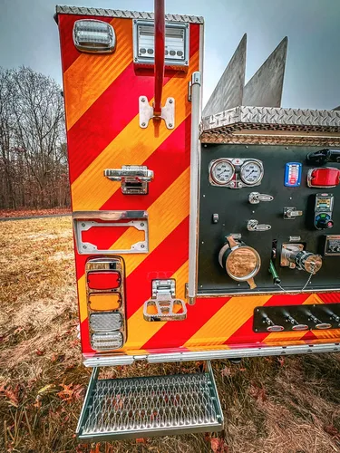 Rear-left corner close-up with taillights and chevron striping.
