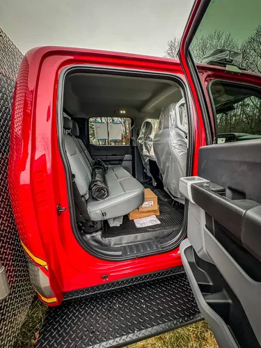 Rear passenger entry view with seat cushions and floor area.