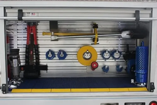 Exterior view of small fire truck showing cab, body compartments, and wheel/tire area.