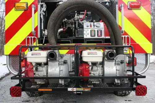 Exterior view of small fire truck showing cab, body compartments, and wheel/tire area.