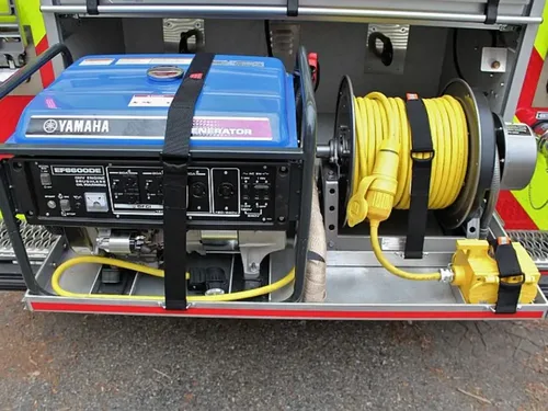 Exterior view of small fire truck showing cab, body compartments, and wheel/tire area.