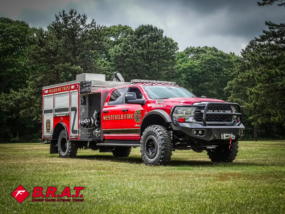 Front-left three-quarter exterior view of the red brush truck on grass.