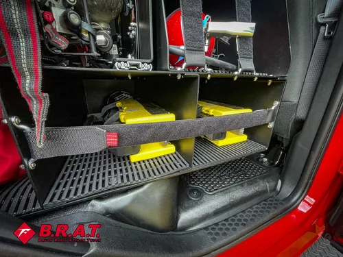 Rear cab floor area with shelves and mounted equipment behind seats.
