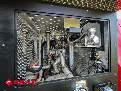 Pump compartment interior showing valves, hoses, and stainless plumbing.