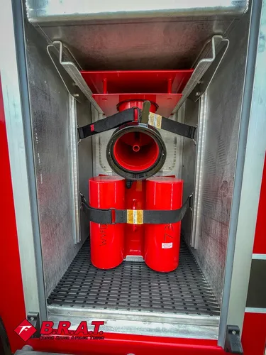 Vertical compartment with red nozzle assembly and mounting bracket.
