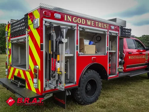 Rear-right side view with multiple compartments open and tools visible.
