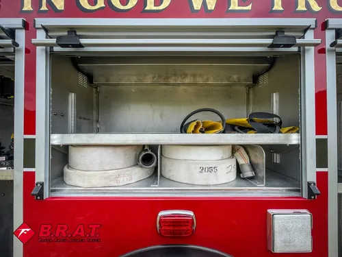 Open side compartment with hose bundle and shelf storage.
