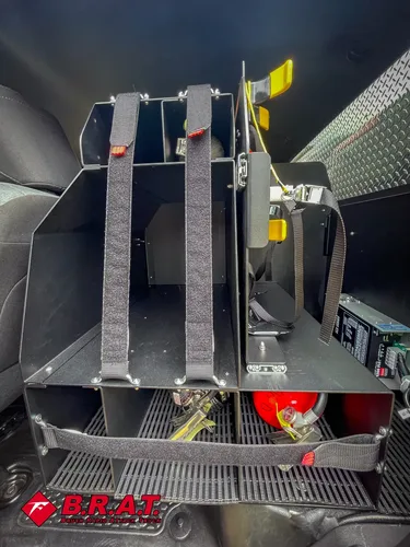 Rear cabin close-up showing tool mounting straps and storage bracket.