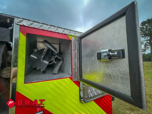 Open rear corner compartment with mounted triangular bracket assembly.
