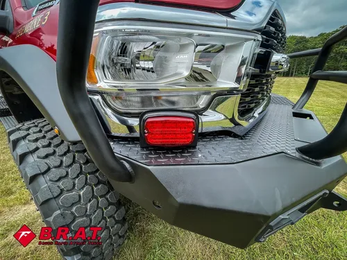 Front corner close-up with headlight cluster and bumper guard.