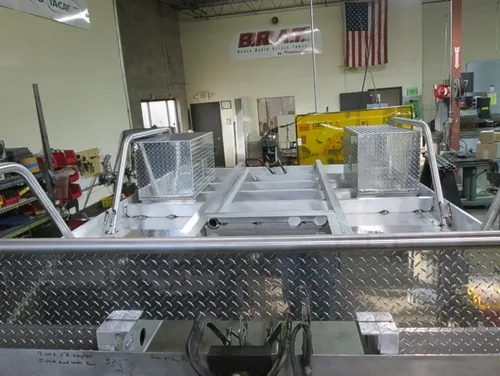 Exterior view of small fire truck showing cab, body compartments, and wheel/tire area.