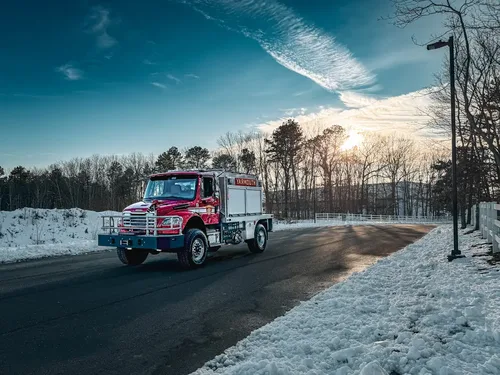 Wide front-left exterior view of the truck on the roadway with compartments closed.