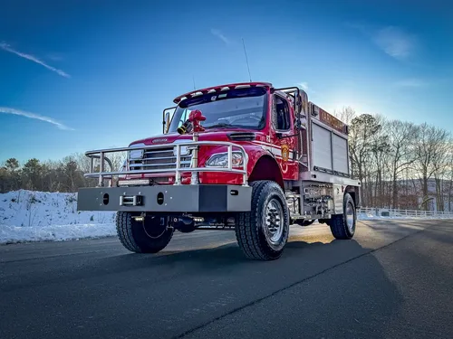 Low-angle front-left view emphasizing the bumper, brush guard, and front tire tread.