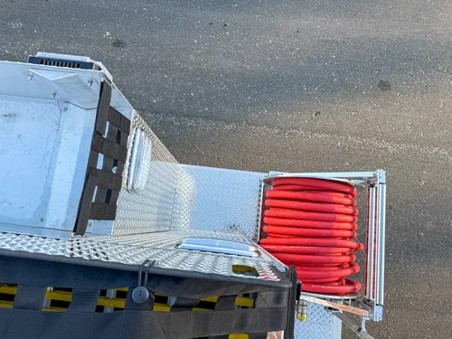 Top-down rear-corner view showing hose reel position below the upper deck.