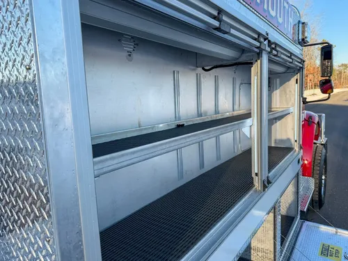 Angled view through open right-side upper compartments with long shelves.
