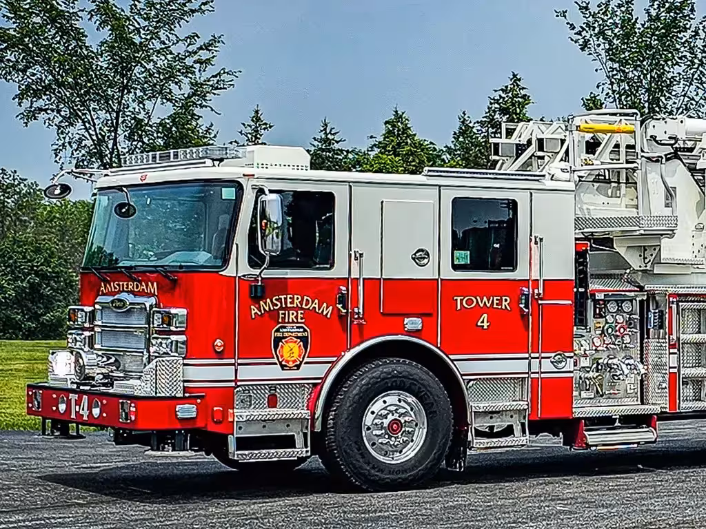 Tower ladder truck front-left exterior view showing aerial sections and cab