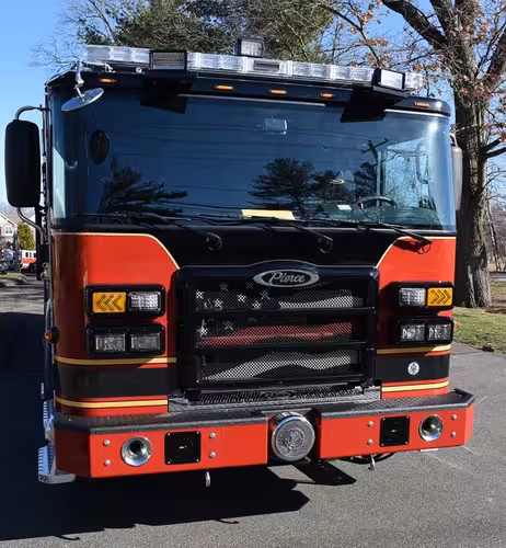 Head-on front view showing grille, bumper intake, and warning lights