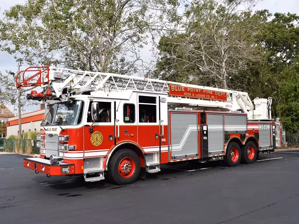 Tower ladder truck front-left exterior view showing aerial ladder and cab
