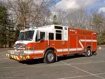 Rescue pumper front-left exterior view showing bumper, cab, and side compartments