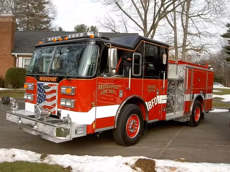 Pumper front-left exterior view in snow showing enclosed cab and side compartments