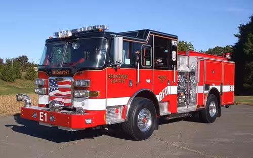 Front-left exterior view showing bumper, cab, and side compartments