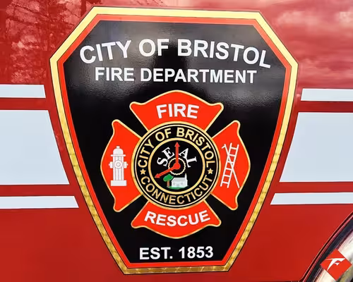 Cab door close-up showing city fire rescue crest on red paint