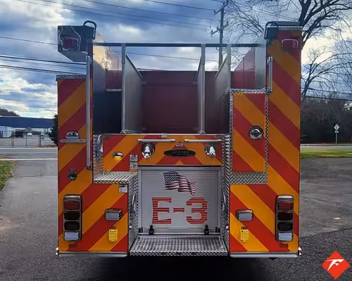 Rear view showing red-and-yellow chevrons and rear center panel