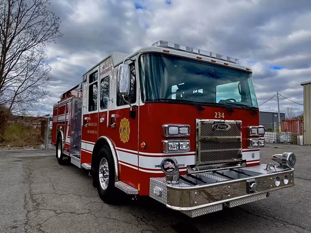 Pumper front-right exterior view showing chrome bumper, grille, and crew cab