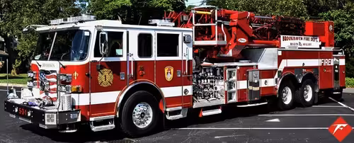 Tower ladder truck front-left profile showing full side body and ladder
