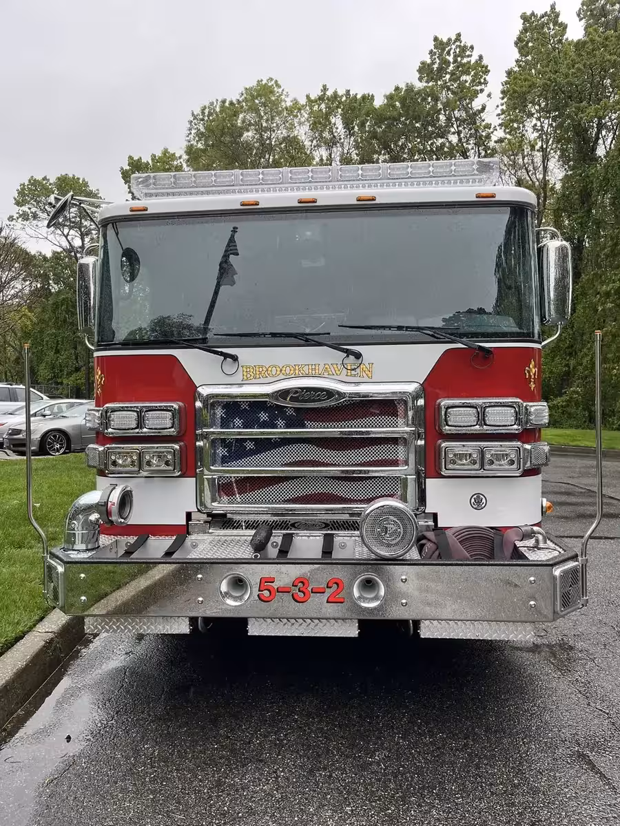 Pumper front view showing grille, bumper intake, and warning lights