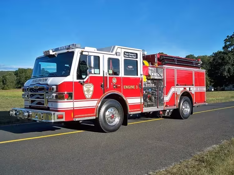 Pumper front-left exterior view showing enclosed cab and side compartments