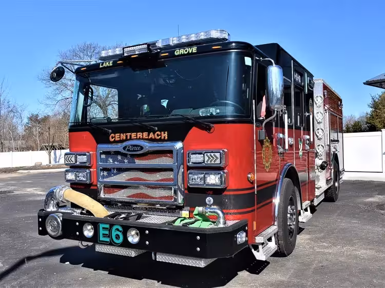 Pumper front-left exterior view showing grille, bumper intake, and crew cab