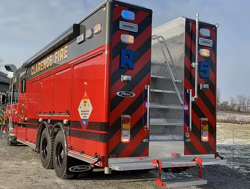 Rear view showing red-and-black chevrons and center access stair