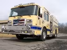 Rescue pumper front-left exterior view showing enclosed cab and side compartments