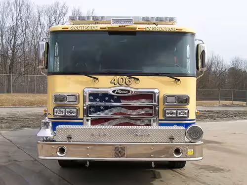 Front exterior view showing grille, bumper, and warning lights