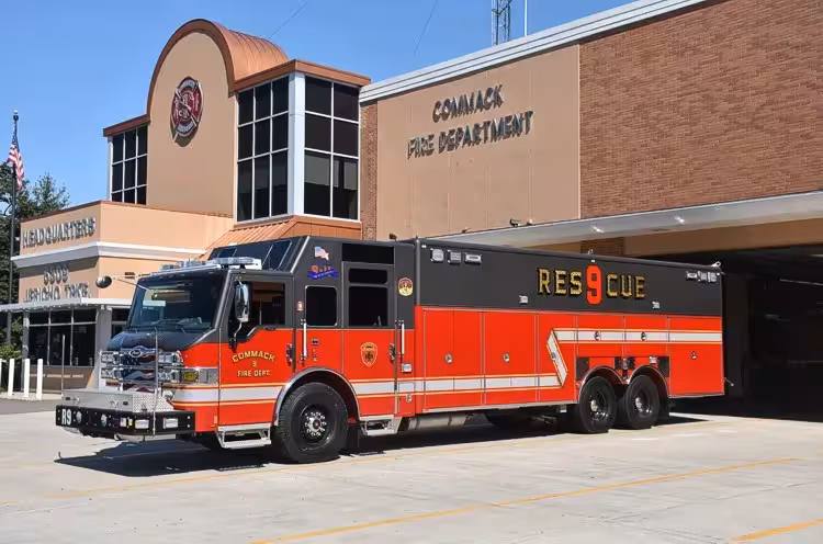 Heavy rescue truck driver-side profile view showing long body and tandem rear axles